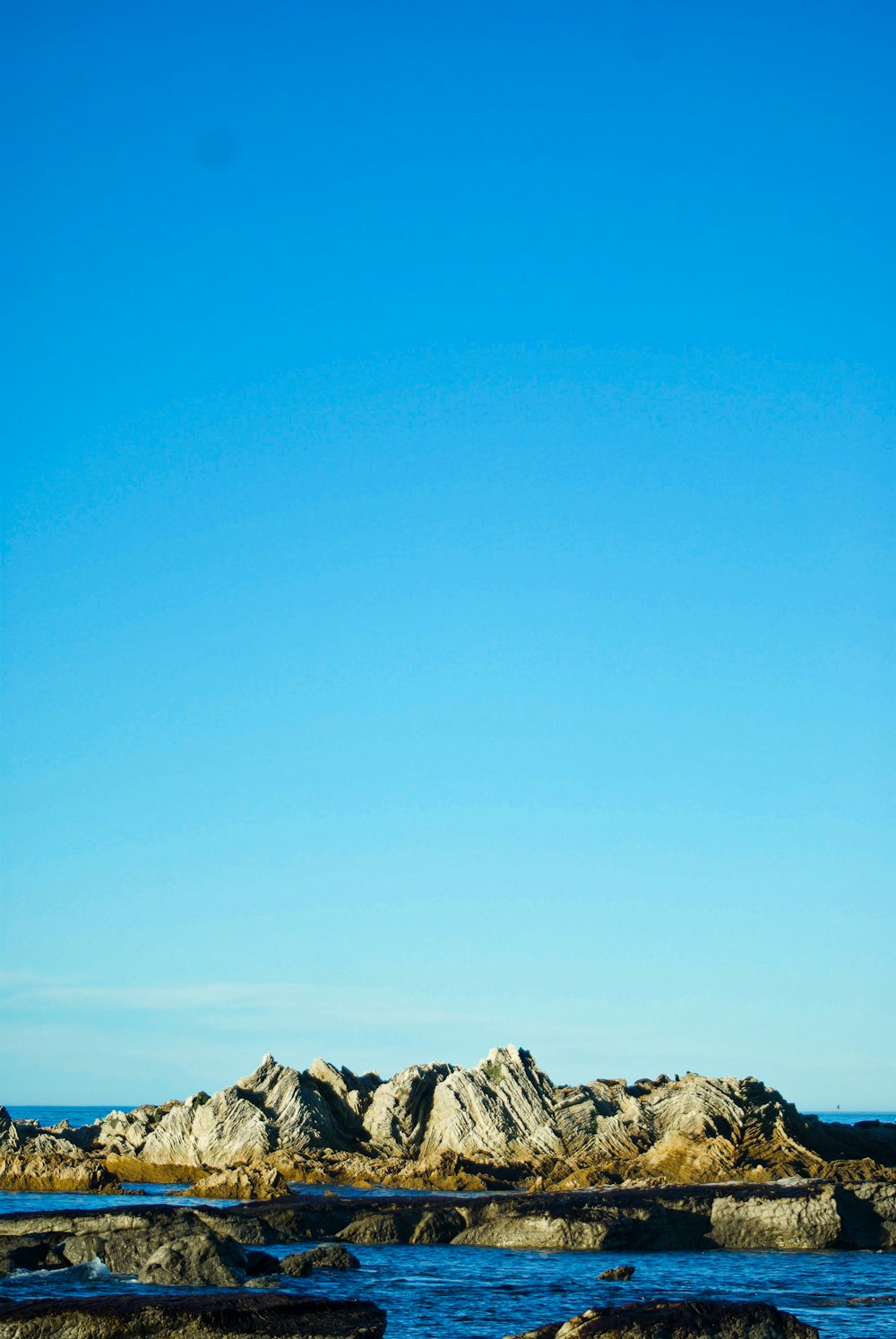 gray rocky mountain under blue sky during daytime