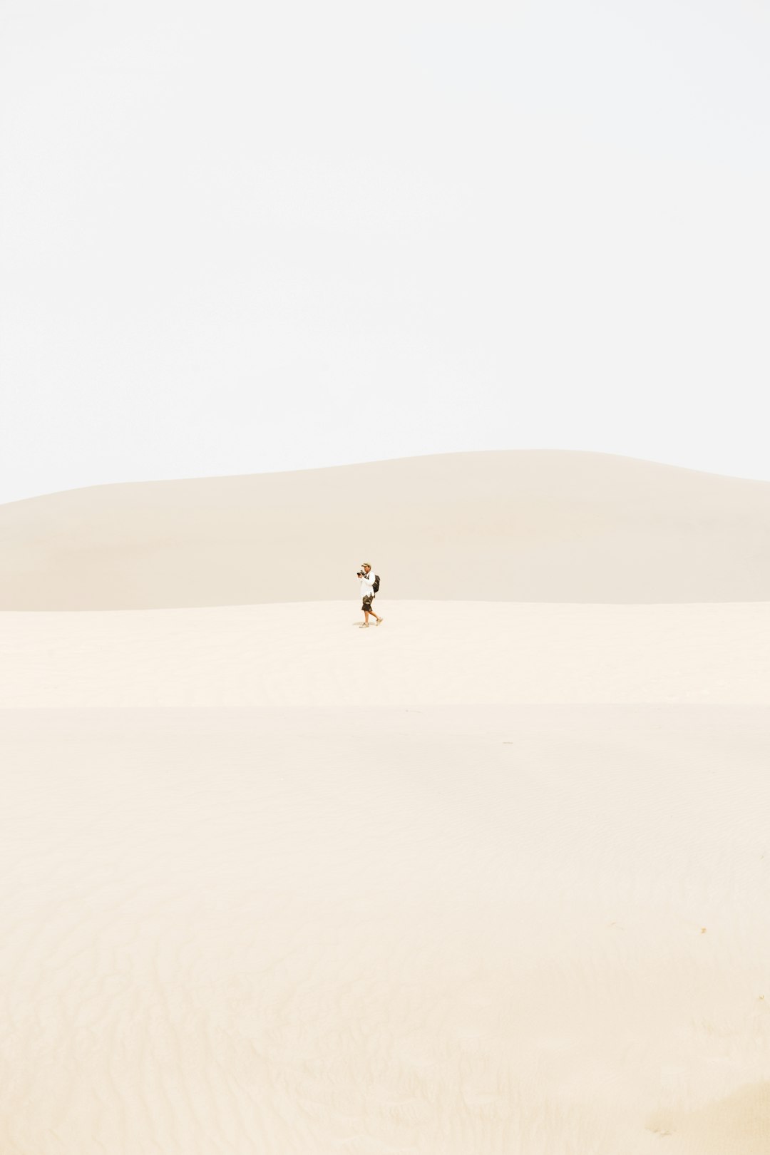 person in the middle of desert during daytime