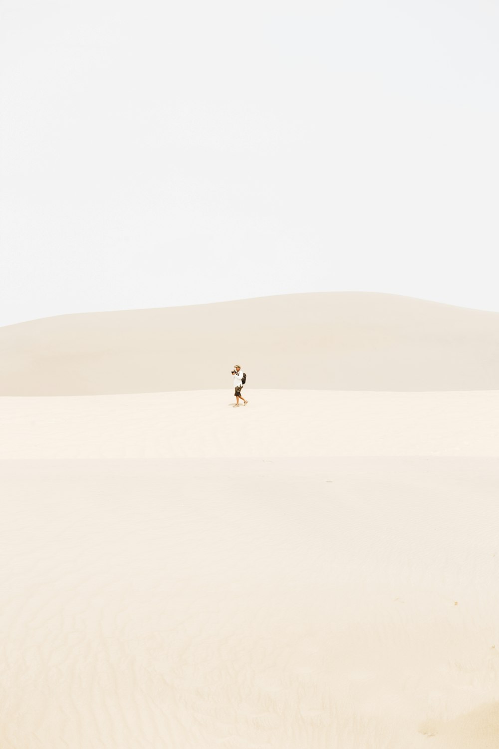 person in the middle of desert during daytime