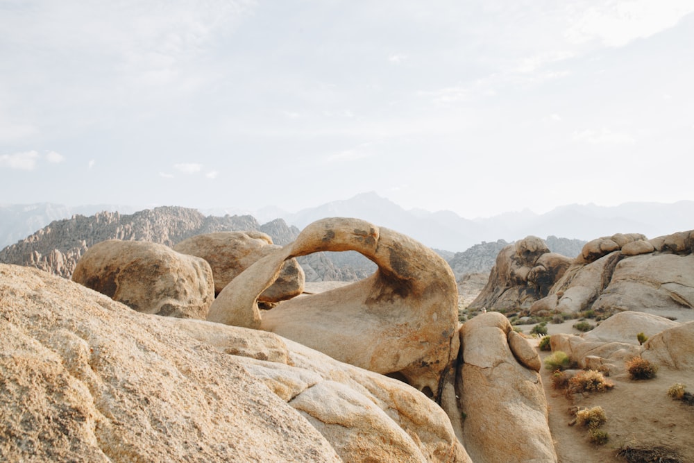 brown rock formation under white clouds during daytime