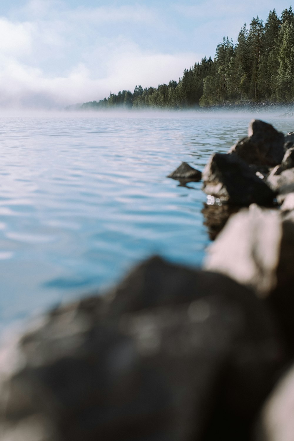 body of water near rocks during daytime