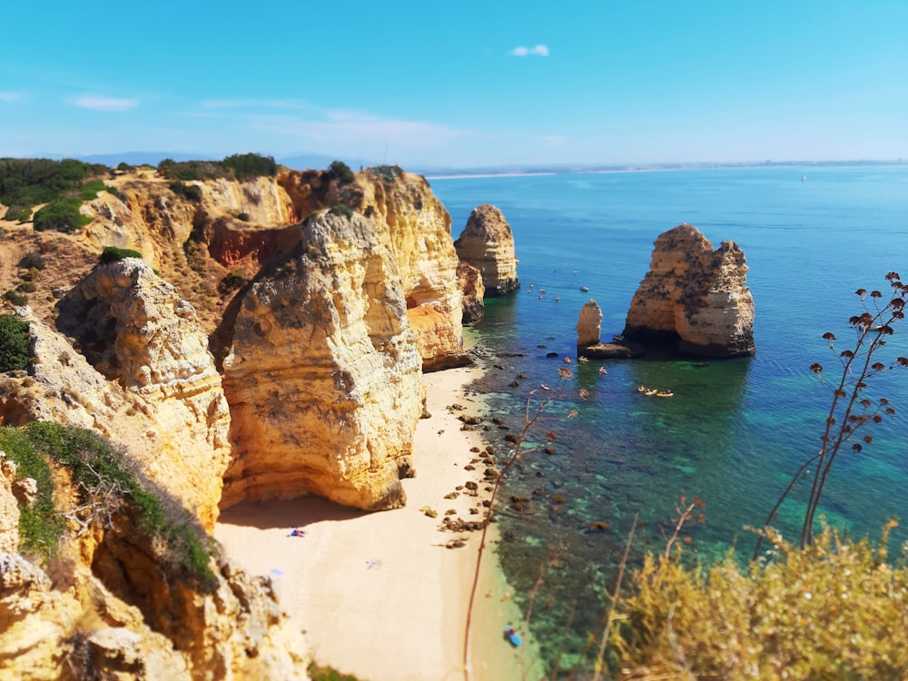 brown rock formation on sea during daytime