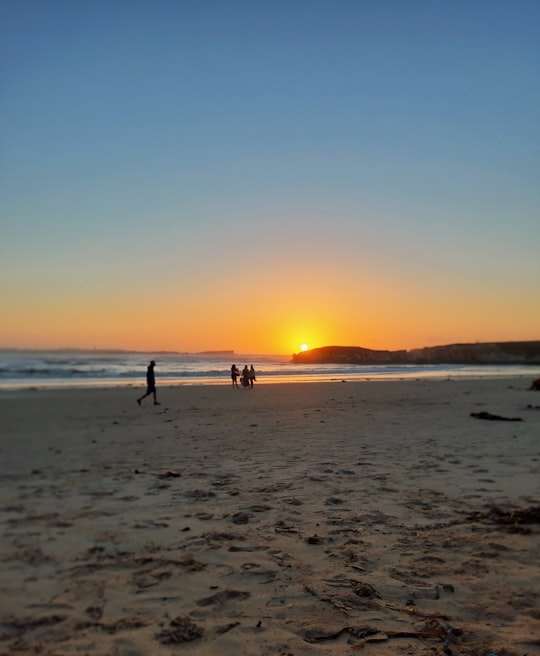 people on beach during sunset in Peniche Portugal