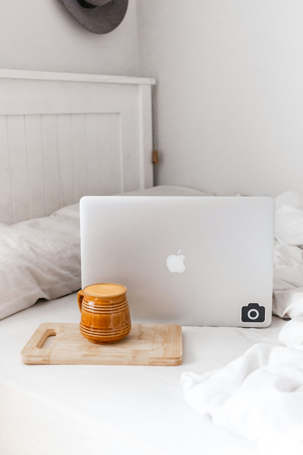 silver macbook on brown wooden table