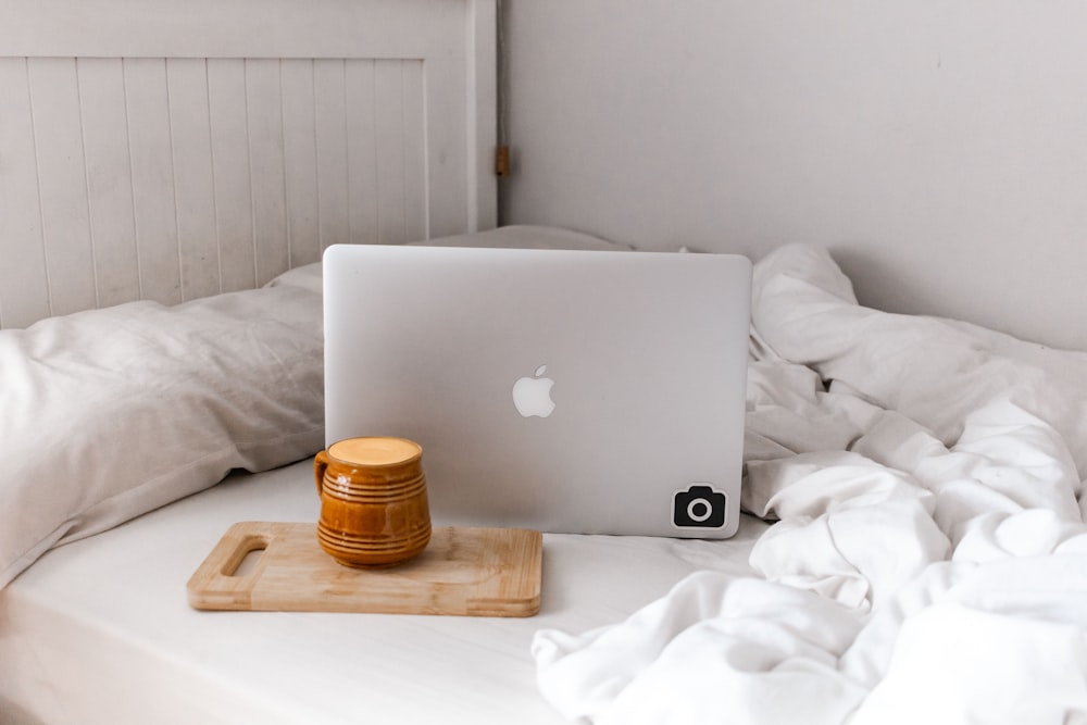 silver macbook on brown wooden table