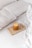 An artistic representation of a curated luxury item in a calm setting.