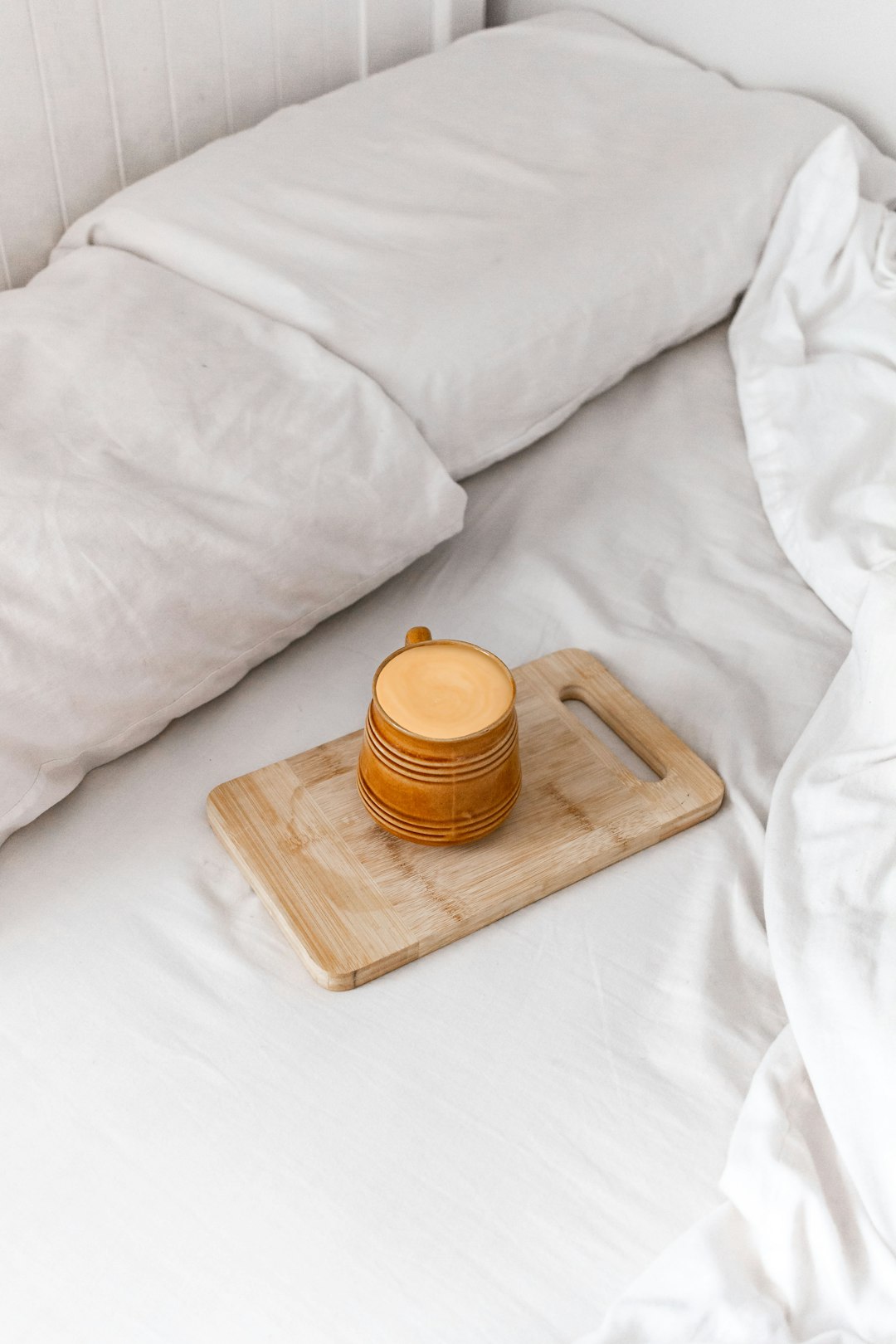 orange plastic jar on brown wooden chopping board