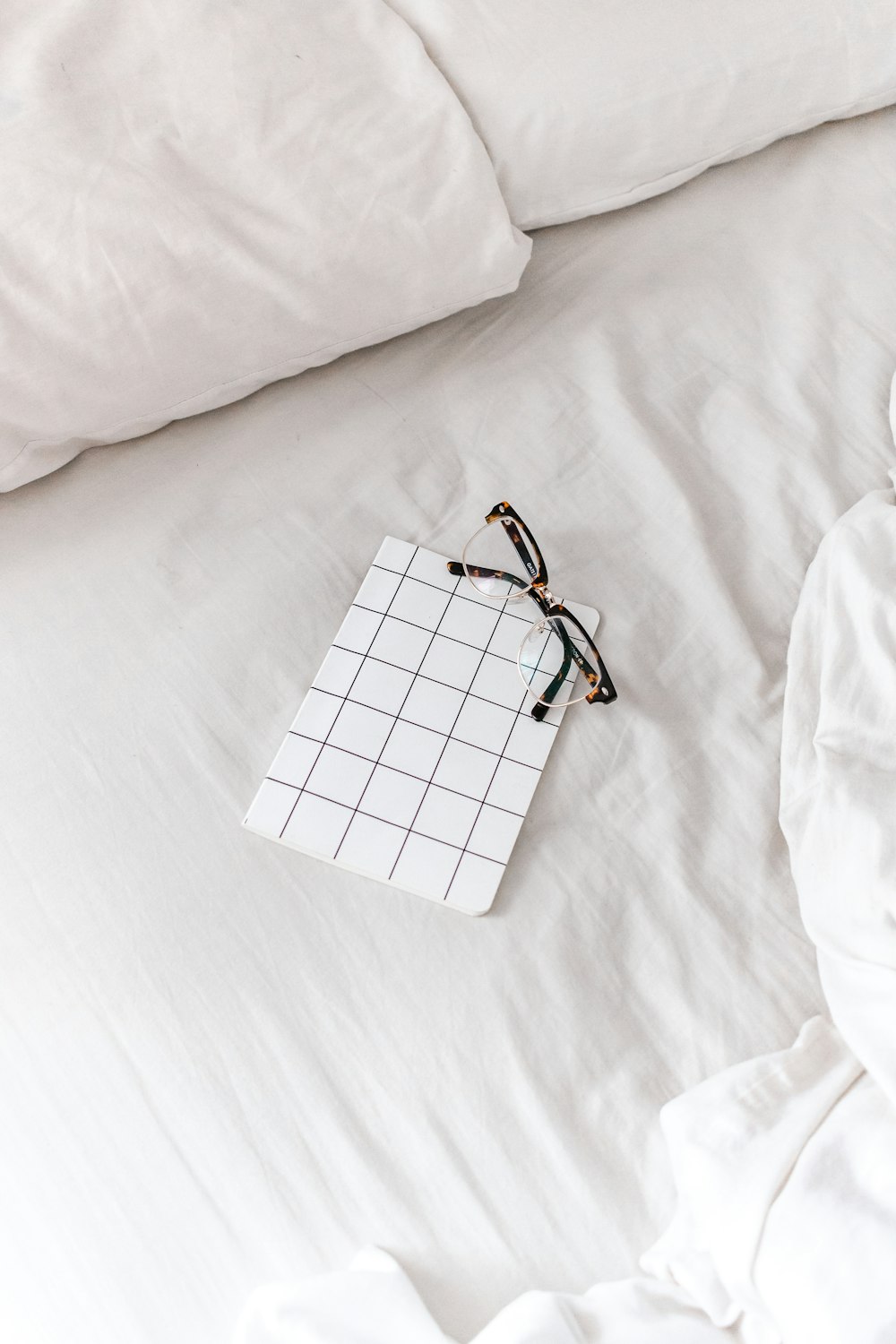 white and black checkered paper bag on white textile