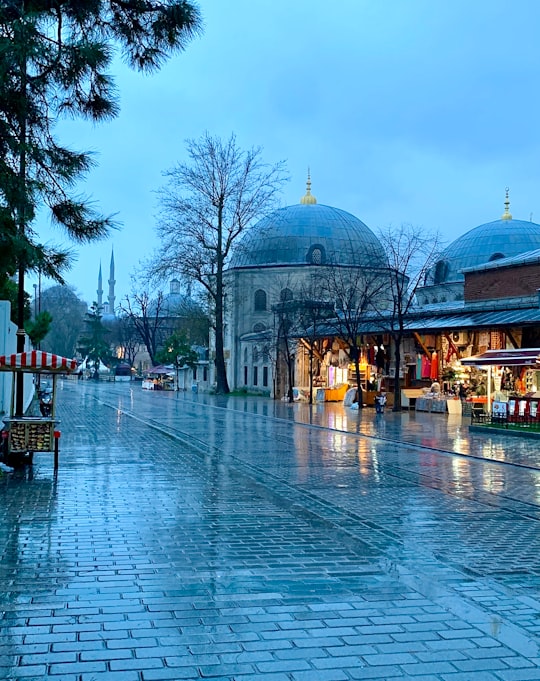 people walking on park near green dome building during daytime in Hagia Sophia Turkey