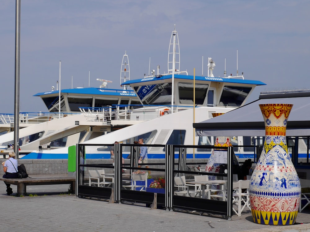 white and blue boat on dock during daytime