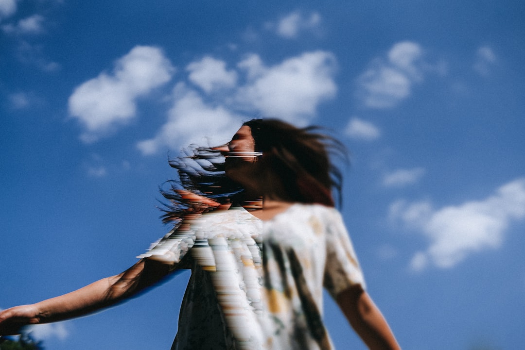 woman in white and black shirt under blue sky during daytime