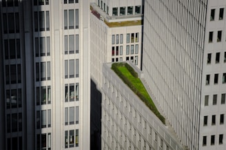 Modern commercial building with green rooftop gardens.