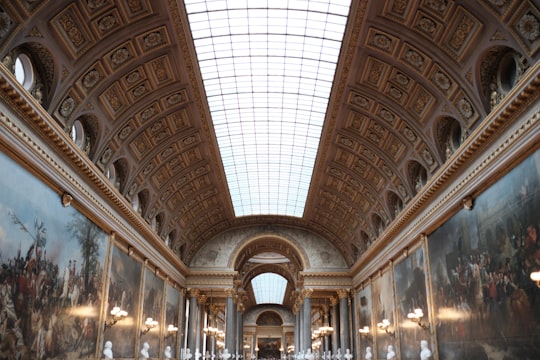 people walking inside building during daytime in Palace of Versailles France