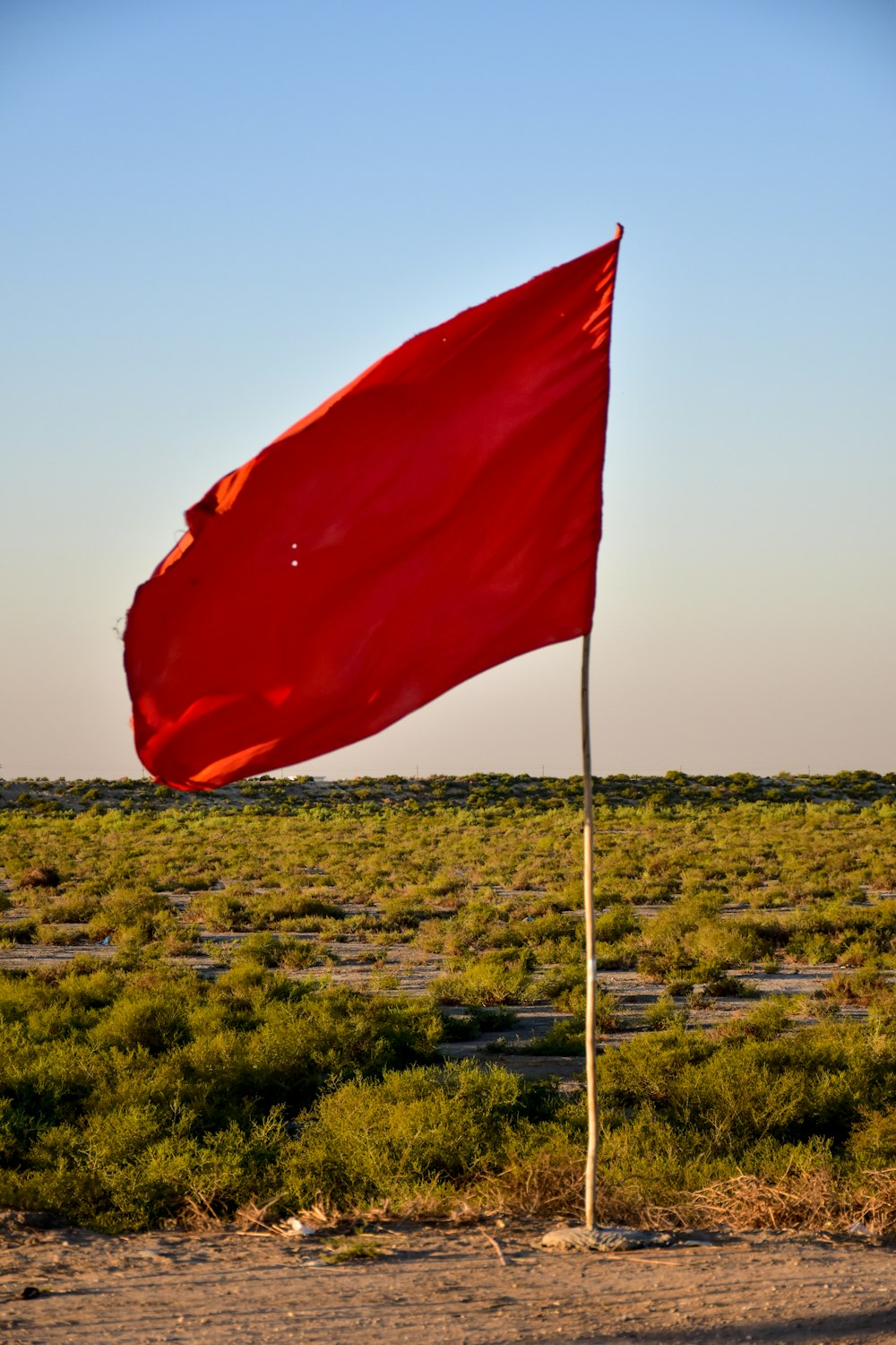 red flag on white pole