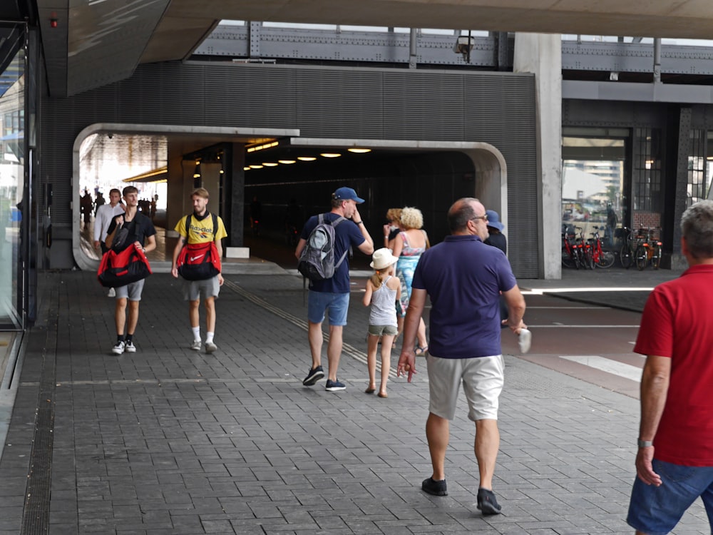 people walking on sidewalk during daytime