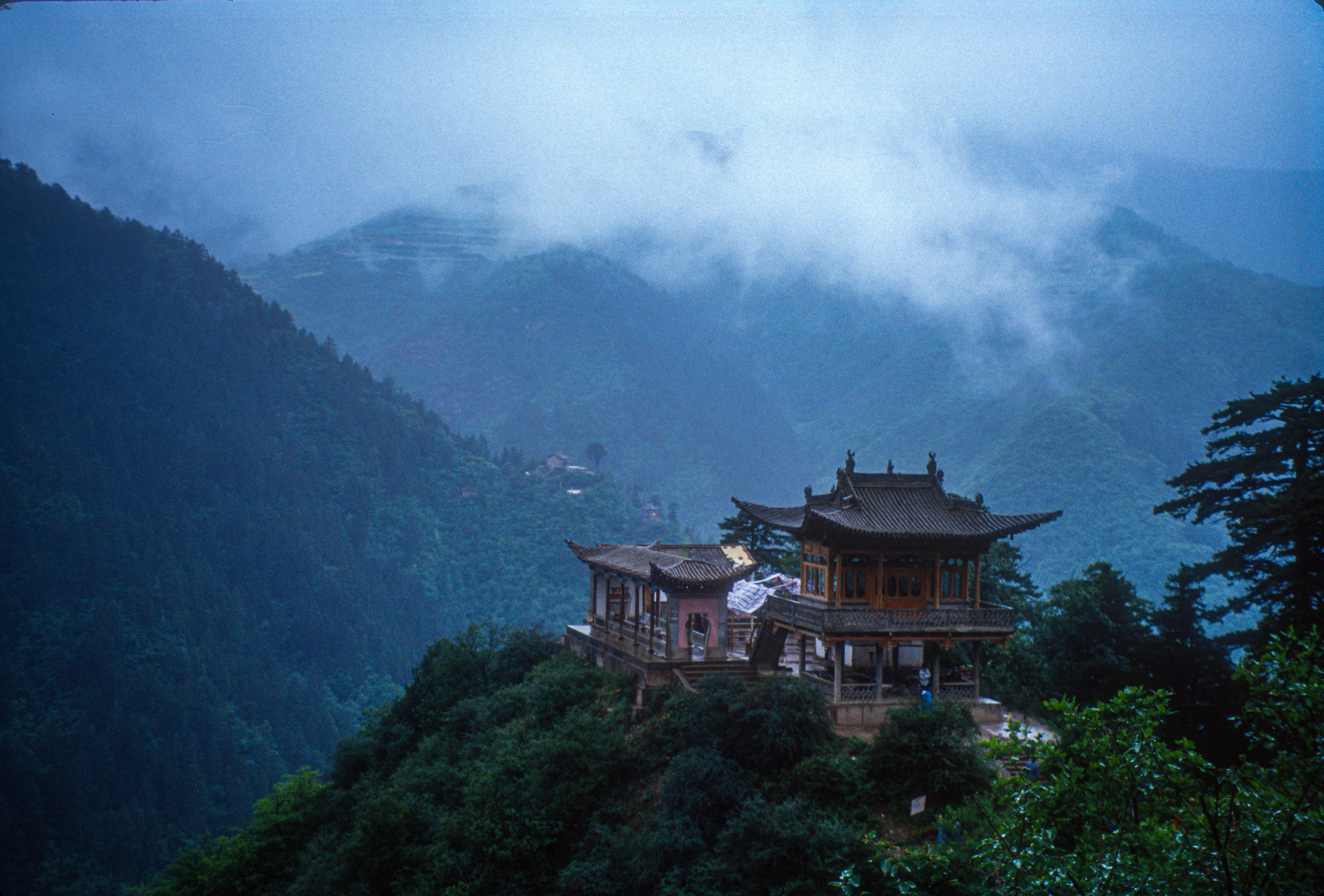 brown and white house on top of mountain