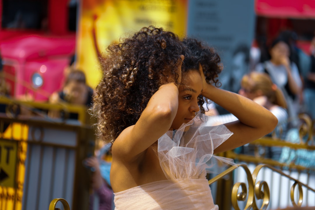 woman in white dress holding her hair