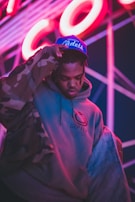 man in blue hoodie wearing blue and red cap
