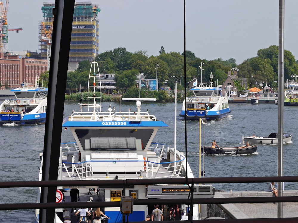 white and blue boat on dock during daytime