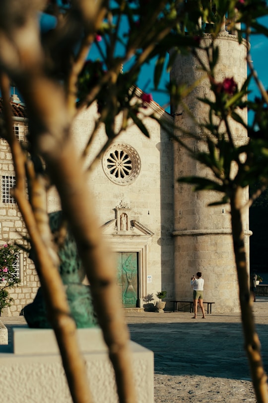 people walking on sidewalk near building during daytime in Perast Montenegro