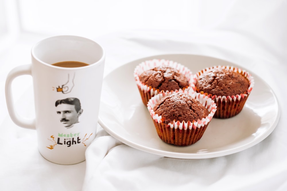 cupcakes on white ceramic plate beside white ceramic mug