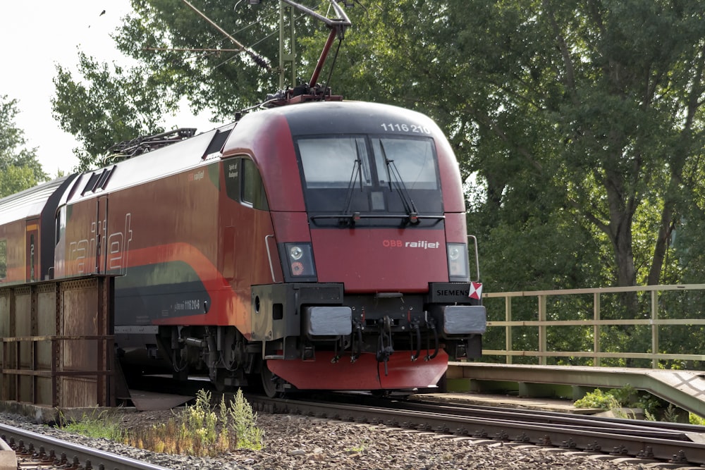 red and black train on rail tracks