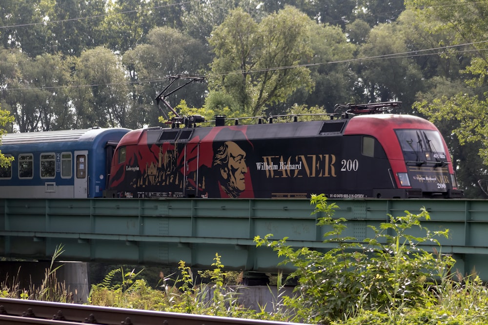 red and green train on rail tracks