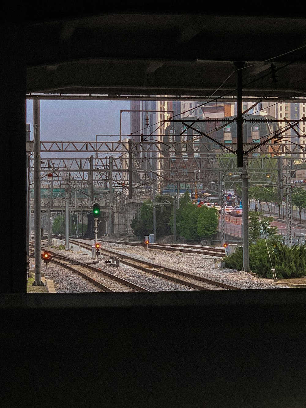 train rail near green trees during daytime