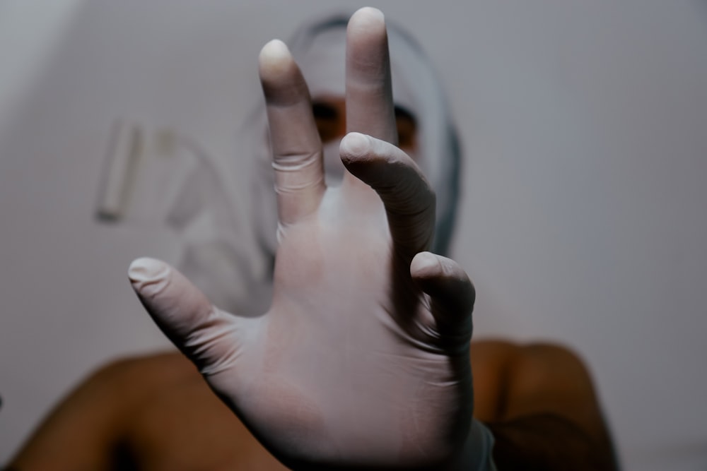 persons hand with white manicure