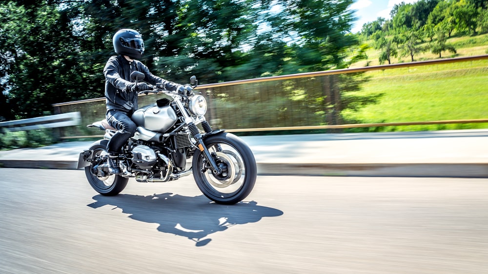 man riding motorcycle on road during daytime