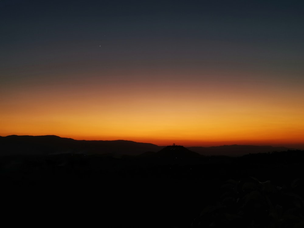 silhouette of mountain during sunset