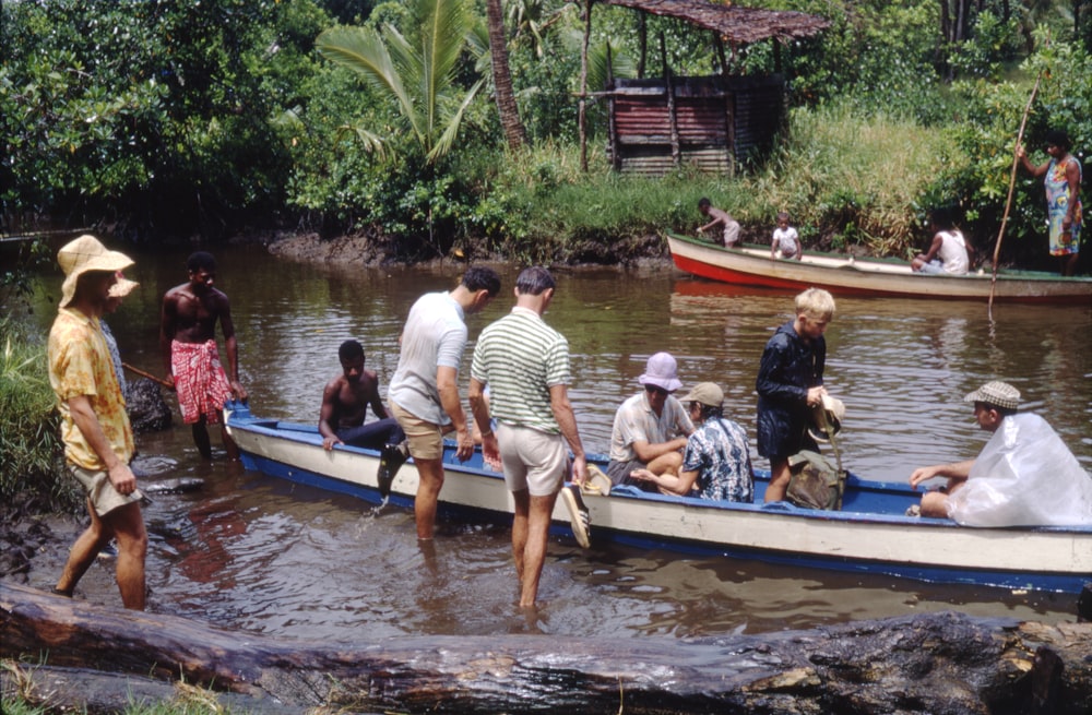 people riding on boat on river during daytime