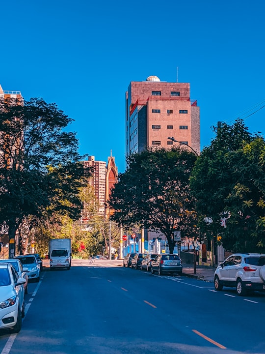 cars parked on side of the road near high rise buildings during daytime in Belo Horizonte Brasil