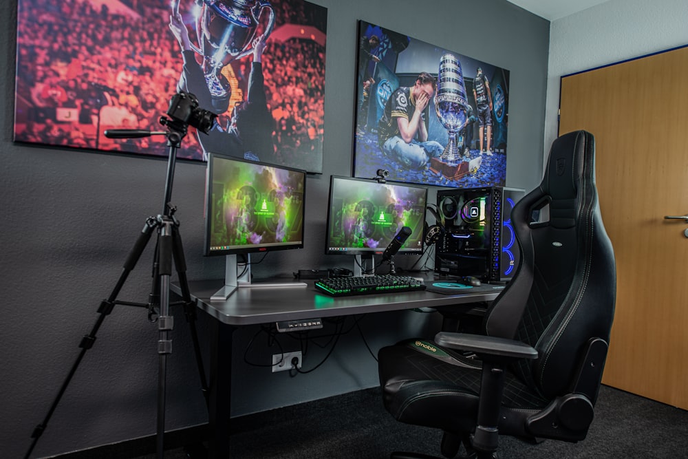 black flat screen computer monitor on black wooden desk