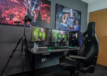 black flat screen computer monitor on black wooden desk