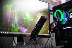 black microphone beside black flat screen computer monitor