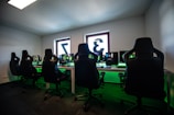 black office rolling chair near black flat screen computer monitor