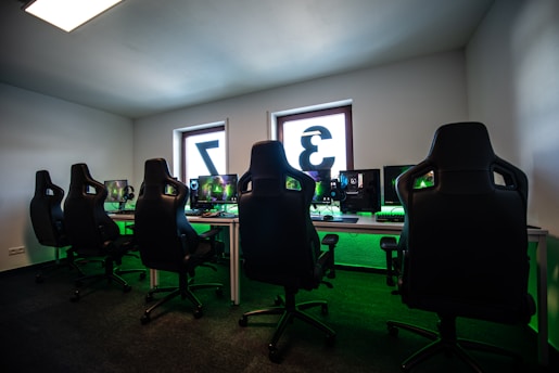 black office rolling chair near black flat screen computer monitor