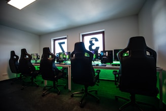 black office rolling chair near black flat screen computer monitor