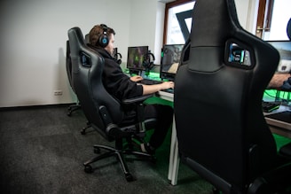 woman in black jacket sitting on black office rolling chair