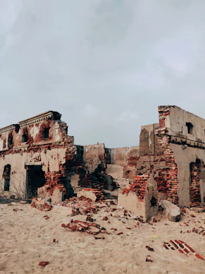 brown concrete building under white clouds during daytime