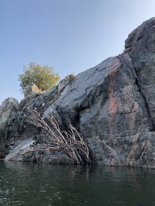 gray rocky mountain beside body of water during daytime in Cauvery River India