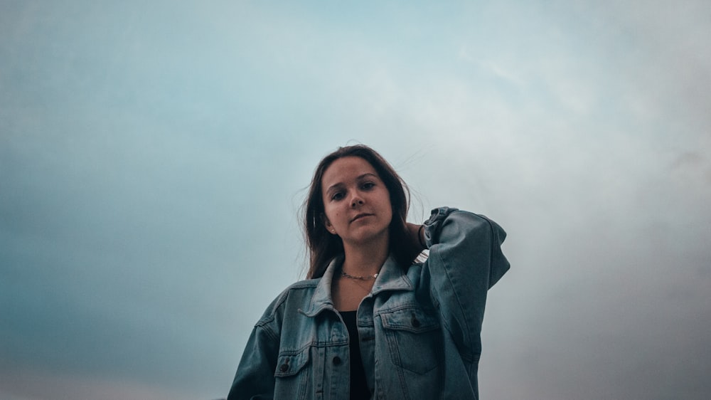 woman in blue denim jacket smiling