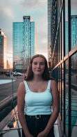 woman in blue tank top standing near black metal railings during daytime