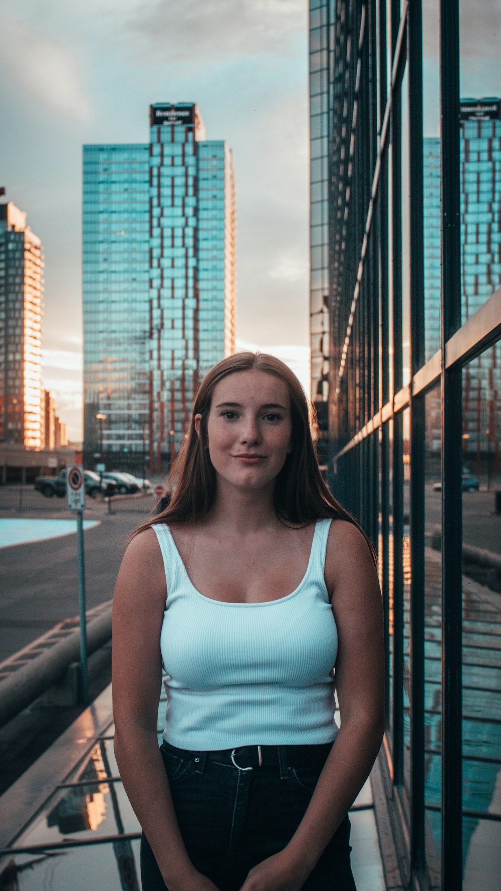 woman in blue tank top standing near black metal railings during daytime