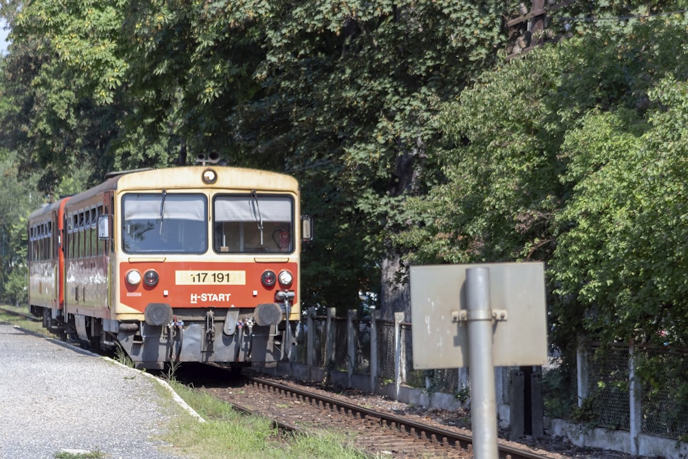 red and black train on rail tracks