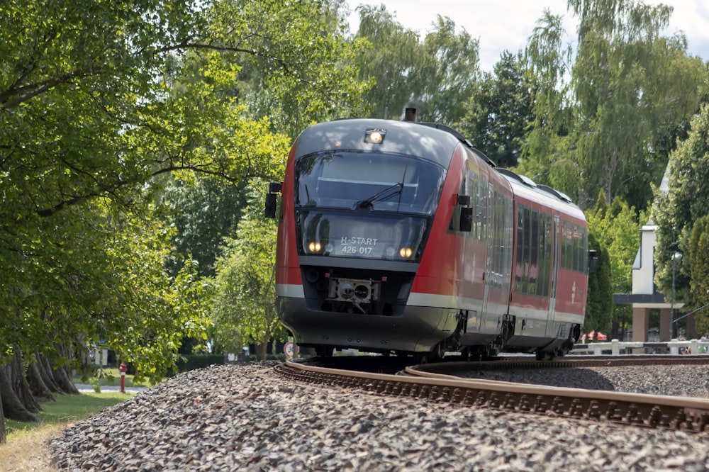 red and gray train on rail tracks