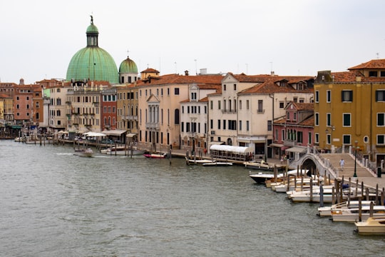 white and brown concrete building near body of water during daytime in San Simeone Piccolo Italy