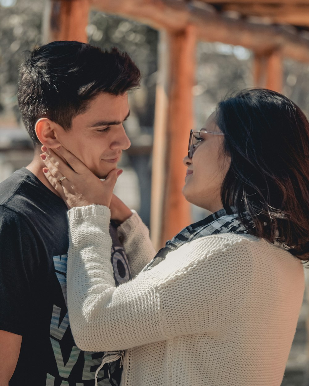 man and woman kissing during daytime