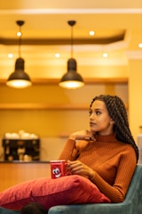 A stylish woman sitting in a cozy café, smiling.
